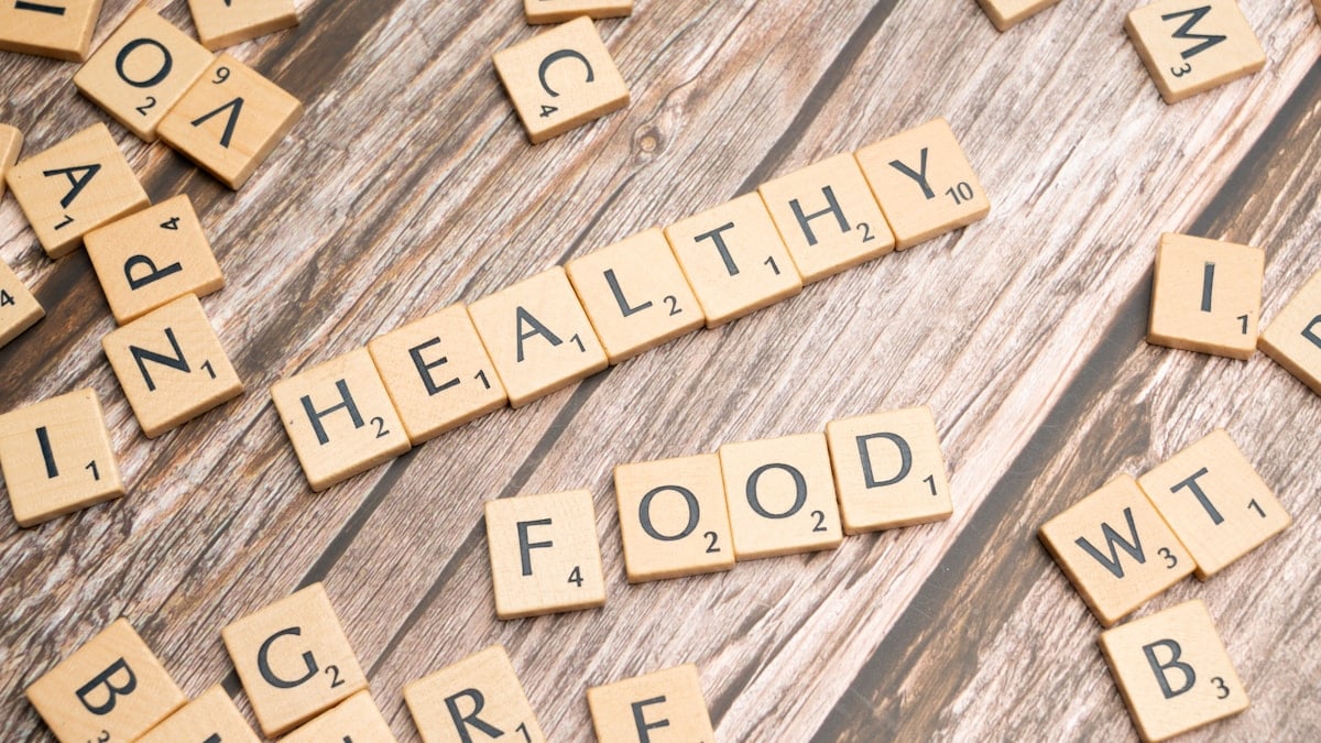 scrabble tiles spelling out the word healthy on a wooden surface